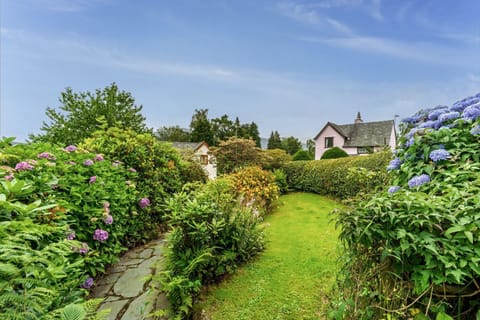 The front garden is surrounded with mature hedgerow so is nice and private