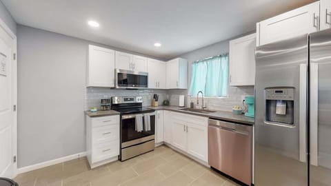 Kitchen has oven, microwave, fridge, and dishwasher