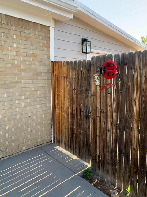 Lower is the back door on the south side of the home through the back gate