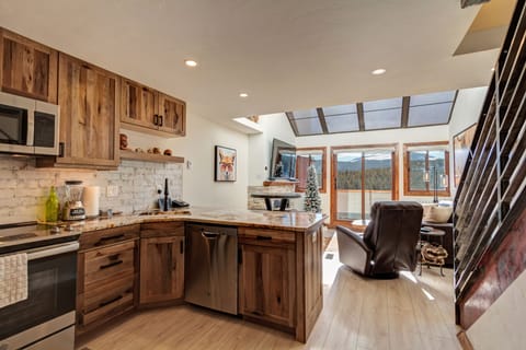 Kitchen includes refrigerator/freezer, electric range, microwave, & dishwasher