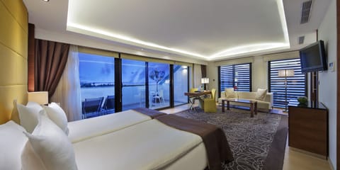 Junior Suite, Partial Sea View | Minibar, in-room safe, desk, soundproofing