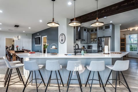 Spacious open floor plan. Seven stools plus seating for 10 at the dining table.