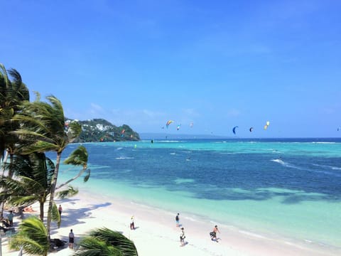 On the beach, white sand, beach towels, motor boating