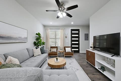 Kick back at Hogan Hideaway—cozy, spacious living room with a large smart TV for movie nights after a day in Point Venture.