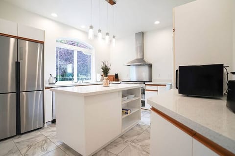 With stainless steel appliances, a gas oven range, and a large center island, it's the perfect place to whip up meals for your stay