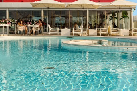 Seasonal outdoor pool, a rooftop pool, pool umbrellas, sun loungers