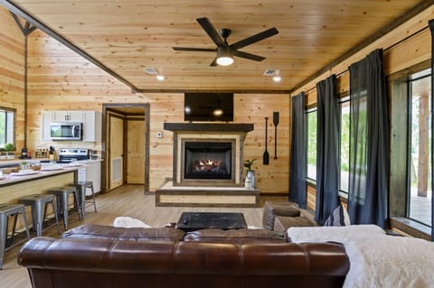 Gather in the living room with a cozy fireplace, Smart TV, and big windows that bring the outdoors in.