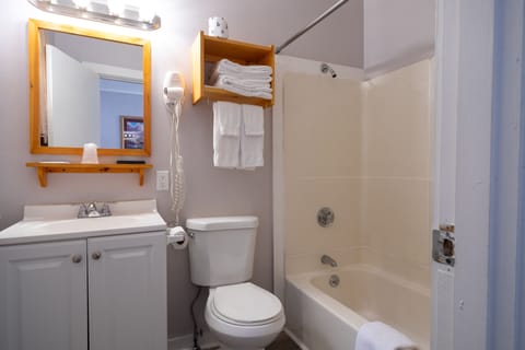 Deluxe Room, 2 Queen Beds | Bathroom | Hair dryer, towels, soap, shampoo