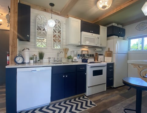 Custom kitchen with dishwasher, marble countertops and hickory beamed ceiling.