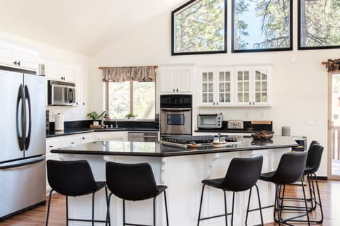 UP TO DATE MODERN KITCHEN WITH BURNERS INSTALLED IN ISLAND ON MAIN FLOOR