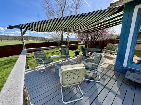 Back porch off the living room with lots of comfortable seating and views.
