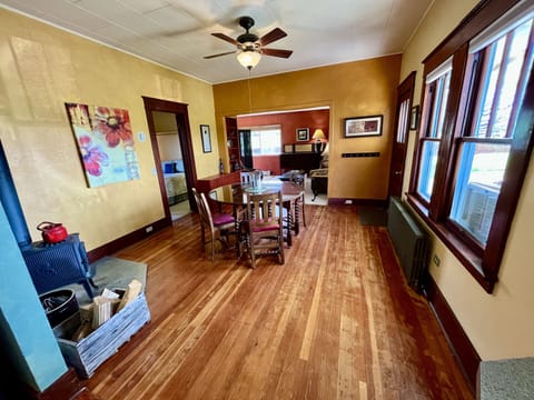 Dining room with lots of natural light and a wood stove.