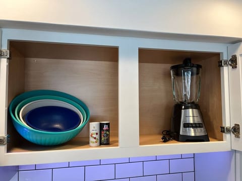 Mixing bowls, blender, and salt + pepper contribute to the fully equipped kitchen.