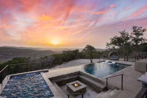 Backyard oasis with stunning sunrises, huge hot tub, and infinity pool overlooking the hills.