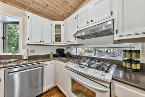 Beautiful cabinets with stove and dishwasher.