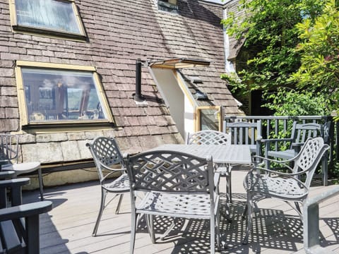 Outside seating area and barbeque. Leading out to rear car park | Newfold Cottage, Bowness-on-Windermere