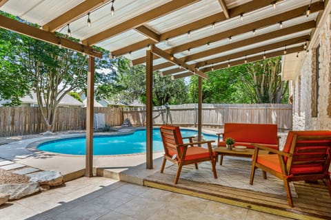 Backyard with relaxing patio, gas grill, and private pool