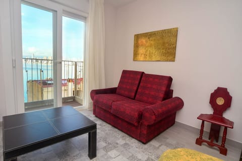 Family Triple Room, Sea View | Living area | 55-inch flat-screen TV with satellite channels