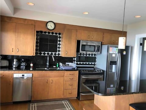 Full Vacation Kitchen, with dishwasher! Has breakfast bar with two chairs.