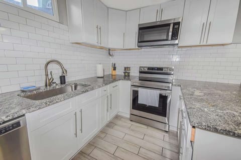 The kitchen is fully equipped with modern appliances, plenty of counter space, and all the essentials you need to prepare meals with ease. It’s a bright, functional space designed for both cooking and casual dining.