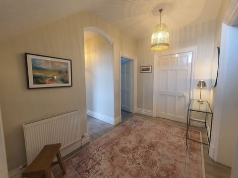 The front door opens into a spacious and elegant hallway