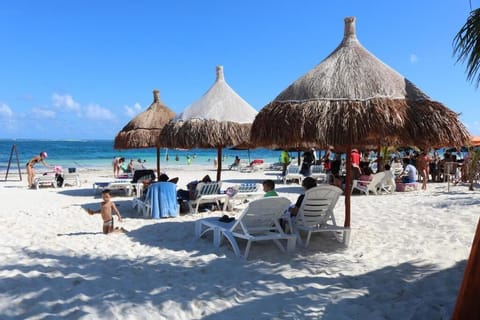 On the beach, white sand, sun loungers, beach umbrellas