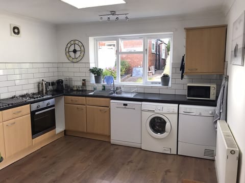 Washing machine and tumble dryer. Retractable washing line available in garden.