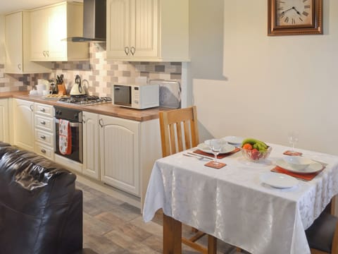 Intimate dining area in open-plan room | Ysgubor Myfi - Trehwfa Cottages, Bodedern, near Holyhead
