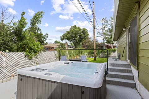 Elevate your outdoor space with a hot tub and grill area.