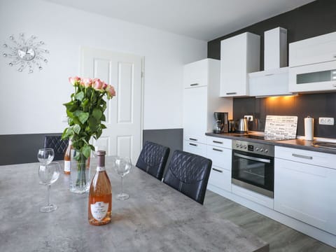 Furniture, Cabinetry, Property, Flower, Countertop, Bottle, Interior Design, Orange, Plant, Kitchen Stove