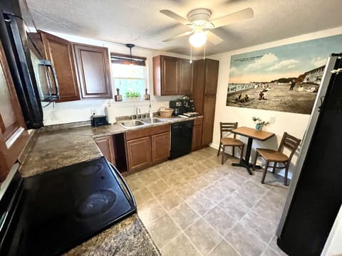 Fully stocked kitchen w/ oven, microwave, refrigerator, dishwasher, & coffee bar