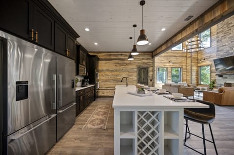 Indulge your culinary senses in our fully stocked kitchen. Featuring a custom double refrigerator, island with a wine rack, and ample space, it's a chef's dream come true. Your culinary adventure begins here!