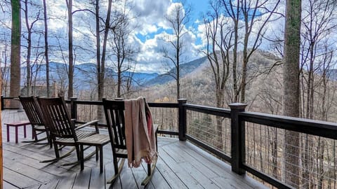 [Back Deck] Relax on a rocking chair and admire the early spring mountain views.