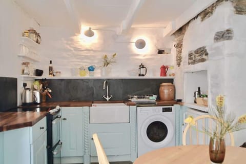 Ground floor: Kitchen and dining area, showing exposed stone walls