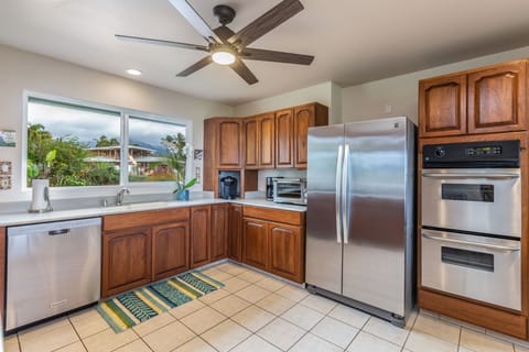The spacious kitchen offers stainless steel appliances, generous counter space, and everything you need for island-inspired meals.