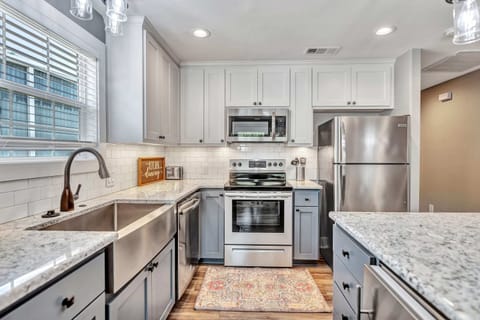 fully stocked kitchen with ice maker and wine fridge in the island!