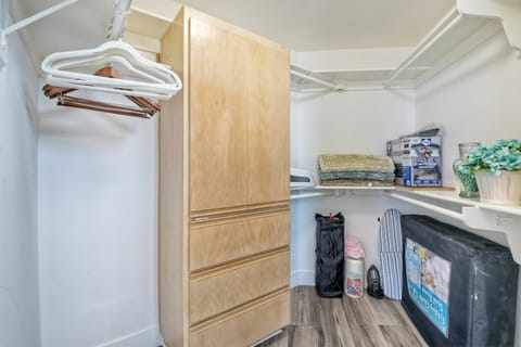 Walk-in closet in Master Suite with pack-n-play and other items for infants