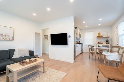 Living Area: Spacious couch, comfortable lounge chairs, 50 inch smart TV, and games.