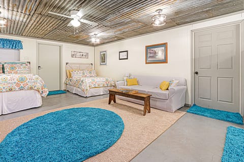 The seating area in front of the full size bed.