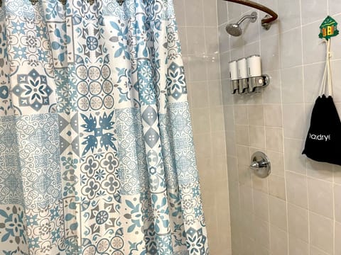 Serene Getaway | Bathroom | Shower, hydromassage showerhead, designer toiletries, hair dryer
