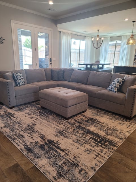 Living room with view of kitchen table in the background