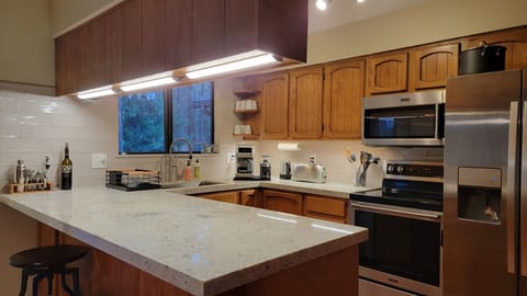 Well equipped kitchen with plenty of pots/pans and cooking tools.