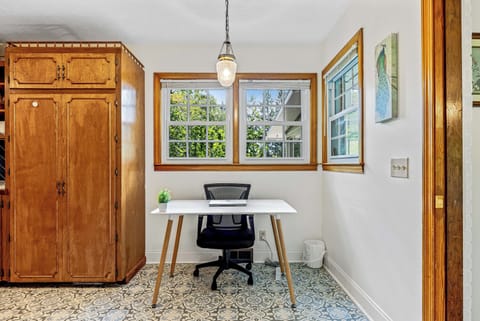 A comfortable work station with surge protector and an ergonomic chair.