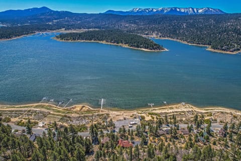 Amazing aerial view of home (red roof) with lake and mountain in front.