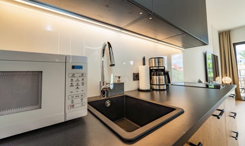 Deluxe Apartment | Private kitchenette | Full-size fridge, microwave, stovetop, dishwasher