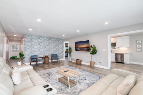 Living room enjoys a large sectional recliner sofa with 65 inch smart tv