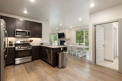 Open concept kitchen, dining, and living area.