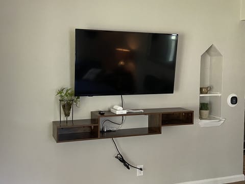 Main floor 50" TV, bluetooth speaker and phone charging station.