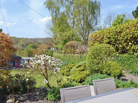 Sitting out area overlooking mature garden | Bee Bowl Cottage, Landcross, near Bideford