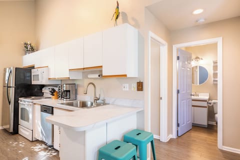 Kitchen features a countertop breakfast bar.